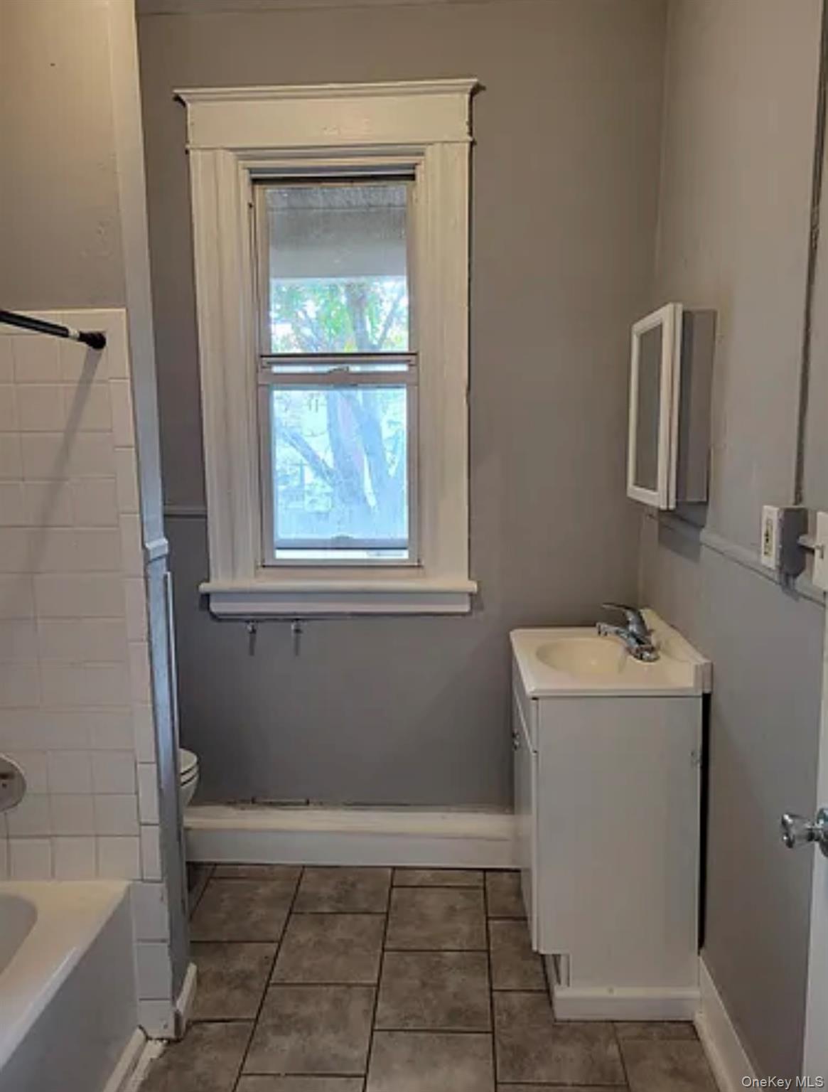 91 Pershing Avenue Poughkeepsie, NY 12601 - Photo 12 of 13 a bathroom with a sink a window and a mirror