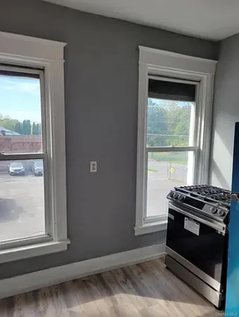 a view of wooden floor and a window in a room