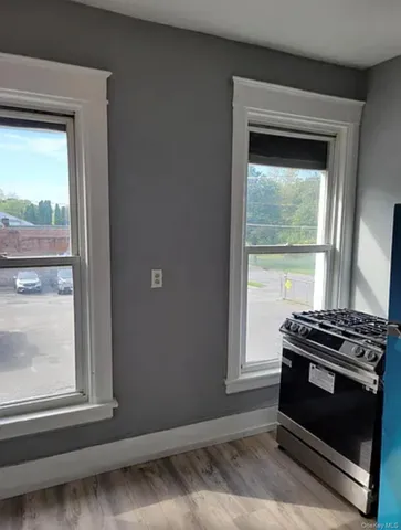 a view of wooden floor and a window in a room
