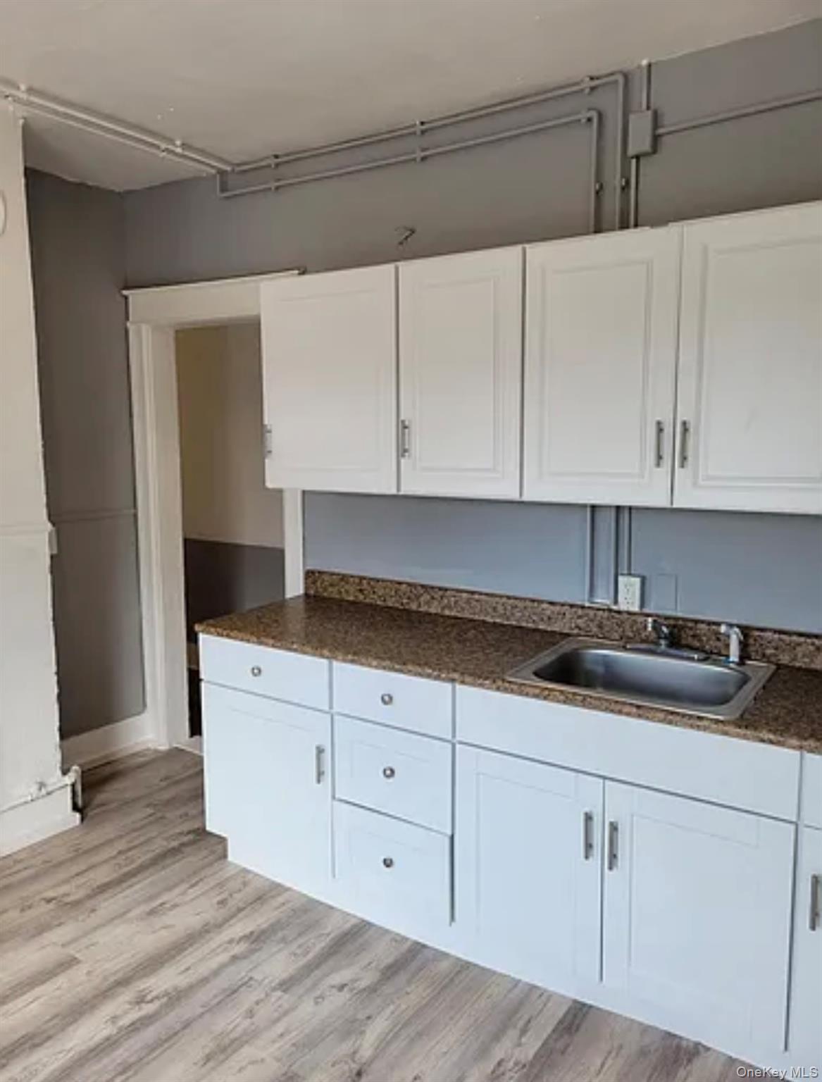 91 Pershing Avenue Poughkeepsie, NY 12601 - Photo 8 of 13 a kitchen with granite countertop white cabinets and sink