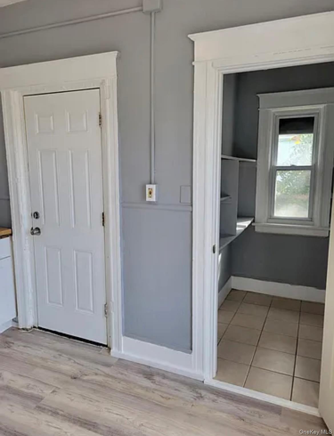 91 Pershing Avenue Poughkeepsie, NY 12601 - Photo 9 of 13 a view of an empty room with wooden floor and a window