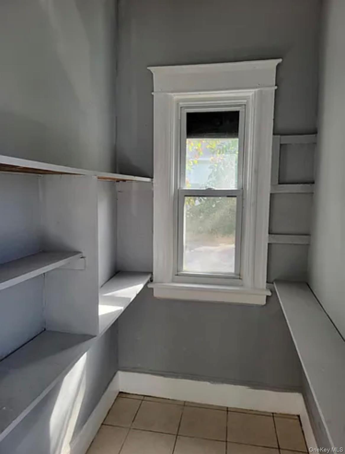 91 Pershing Avenue Poughkeepsie, NY 12601 - Photo 10 of 13 a view of a small space with wooden racks and a window