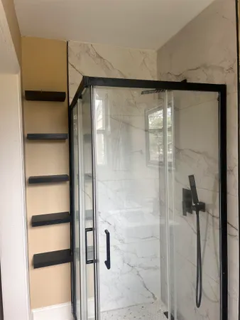 a bathroom with a glass shower door