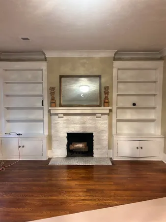 a view of a livingroom with an empty space and a fireplace