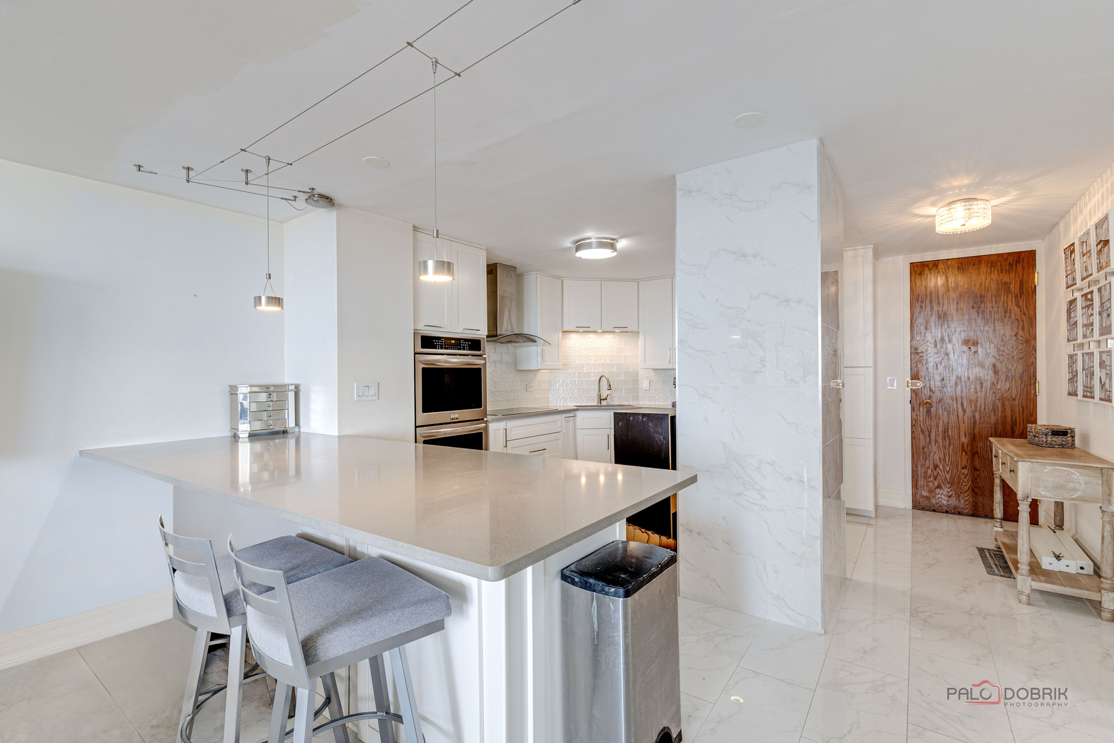 6033 North Sheridan Road, Unit 20K Chicago, IL 60660 - Photo 3 of 25 a kitchen with a table chairs refrigerator and microwave