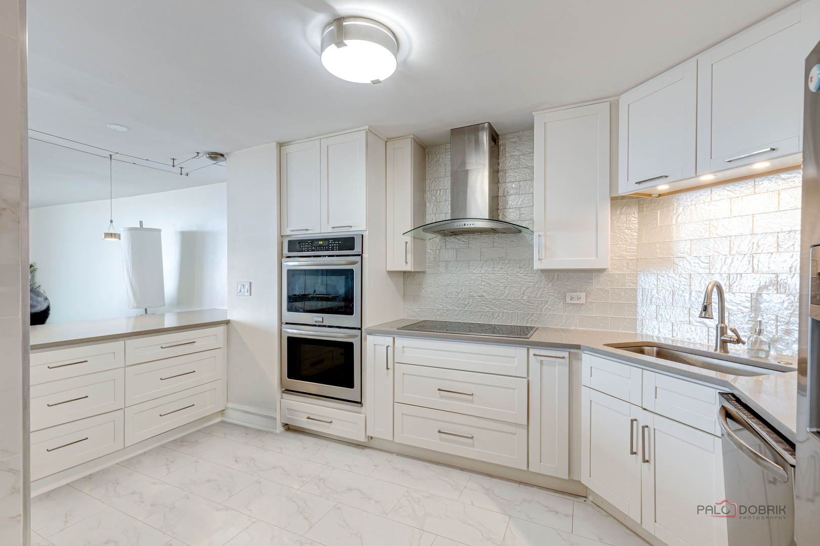 6033 North Sheridan Road, Unit 20K Chicago, IL 60660 - Photo 4 of 25 a kitchen with granite countertop white cabinets and stainless steel appliances