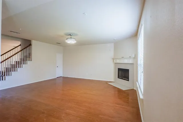 a view of empty room with fireplace