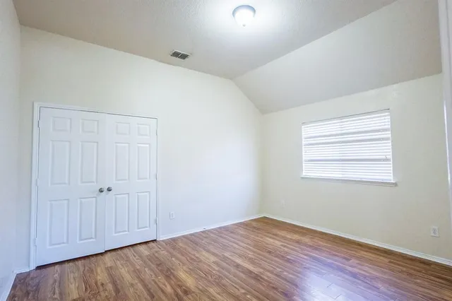 an empty room with wooden floor