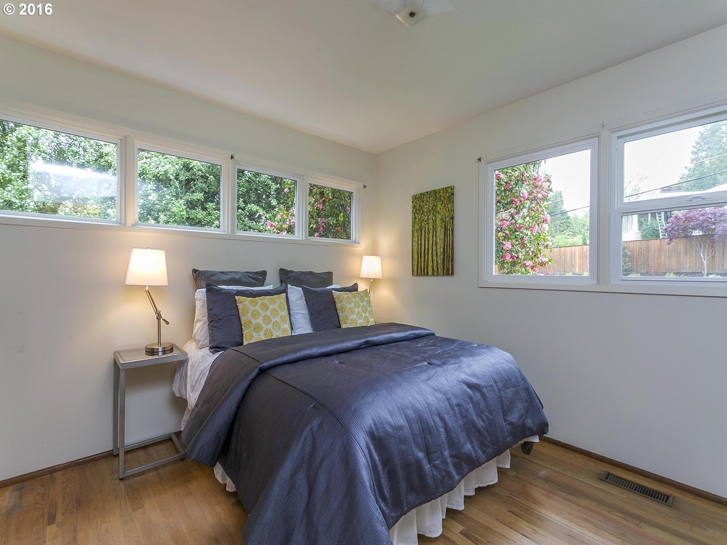 7610 Southwest Miner Way Portland, OR 97225 - Photo 12 of 32 a bed sitting in a bedroom next to a window