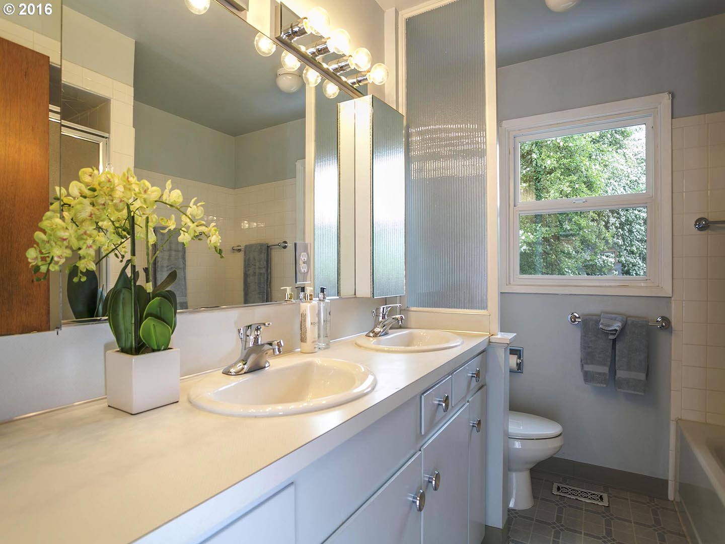 7610 Southwest Miner Way Portland, OR 97225 - Photo 15 of 32 a bathroom with a granite countertop sink a toilet and a mirror