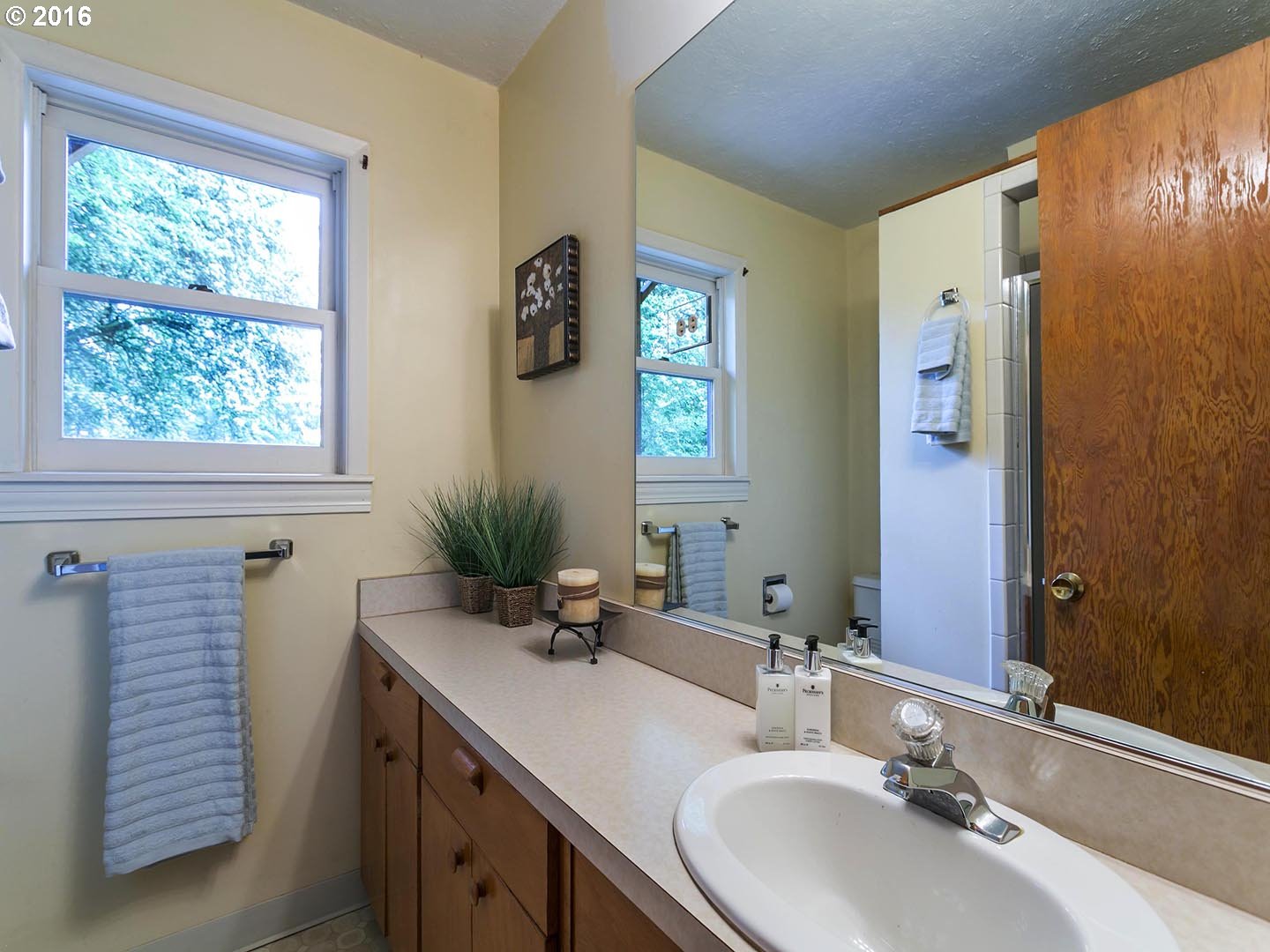 7610 Southwest Miner Way Portland, OR 97225 - Photo 20 of 32 a bathroom with a sink and a mirror