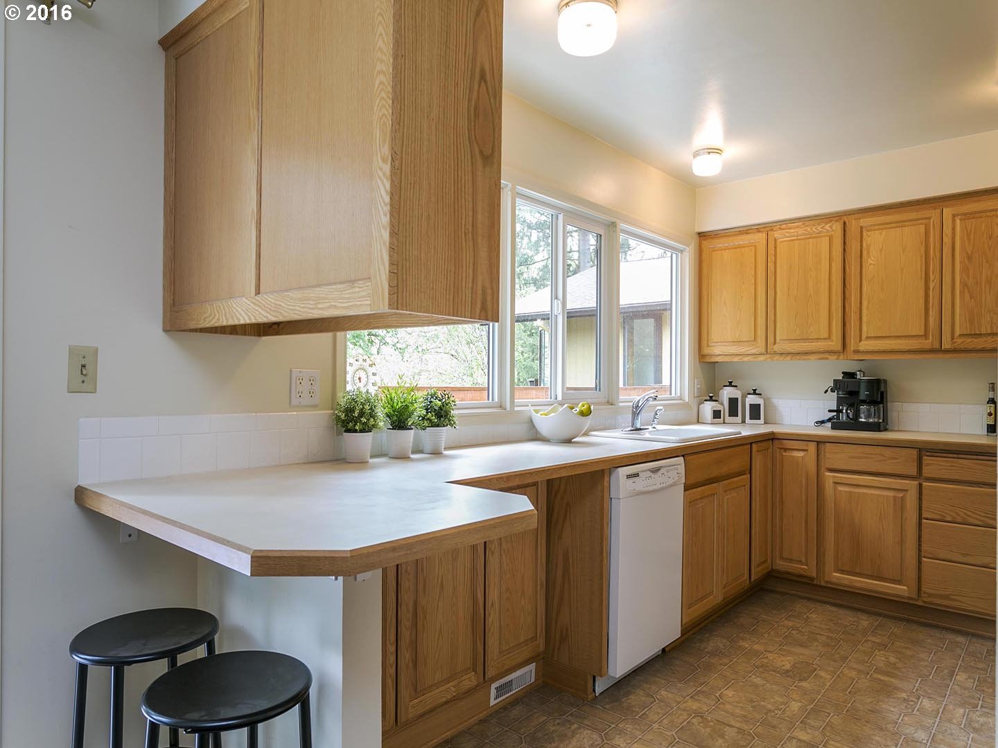 7610 Southwest Miner Way Portland, OR 97225 - Photo 9 of 32 a kitchen with sink cabinets and window