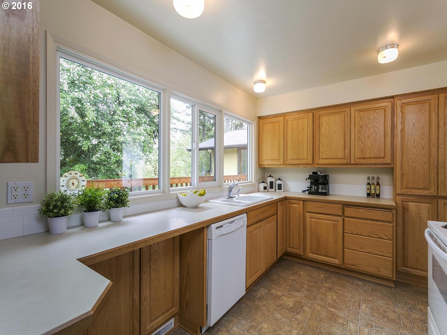 7610 Southwest Miner Way Portland, OR 97225 - Photo 10 of 32 a kitchen with sink cabinets and window