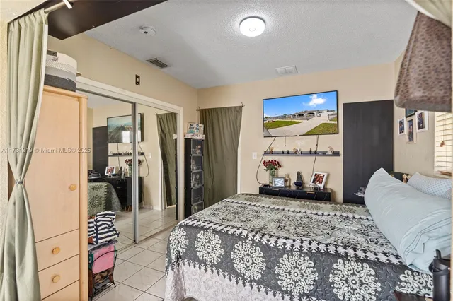 a kitchen with refrigerator and cabinets