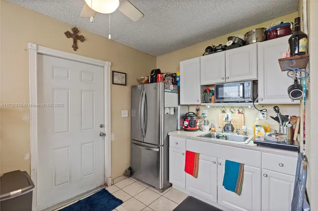 a kitchen with refrigerator a washer and dryer