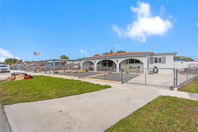 a swimming pool with outdoor seating and yard