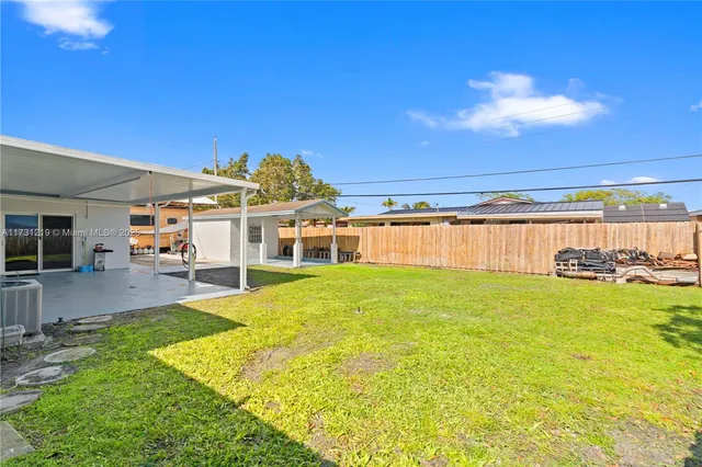 a view of a backyard with swimming pool