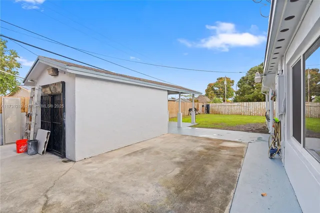 a view of a backyard with a patio