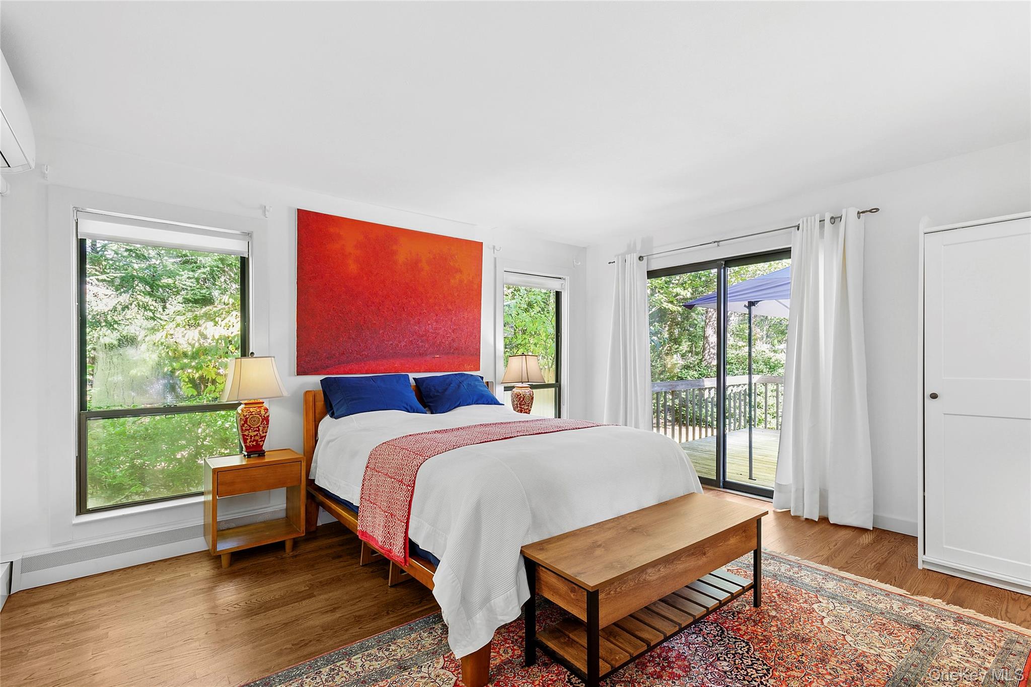98 Hands Creek Road East Hampton, NY 11937 - Photo 11 of 20 Bedroom with access to exterior, wood finished floors, and an AC wall unit