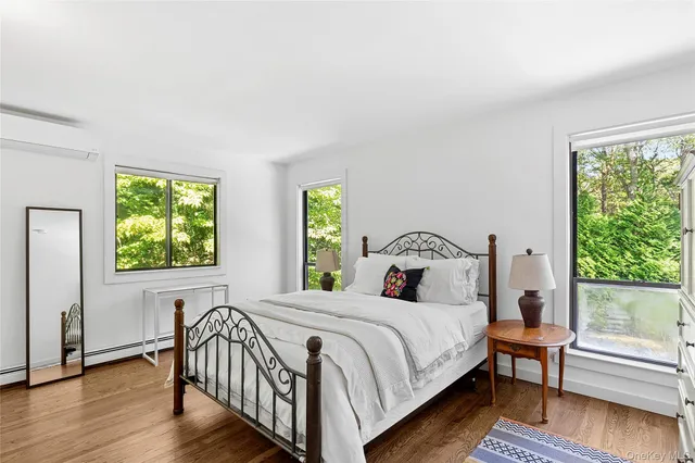 a bedroom with a bed and a large window with outer view