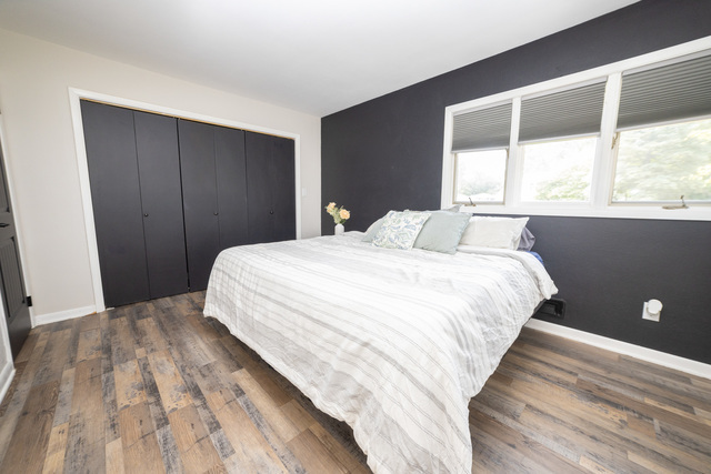 712 Homestead Place Joliet, IL 60435 - Photo 14 of 26 a bedroom with a bed and a large window