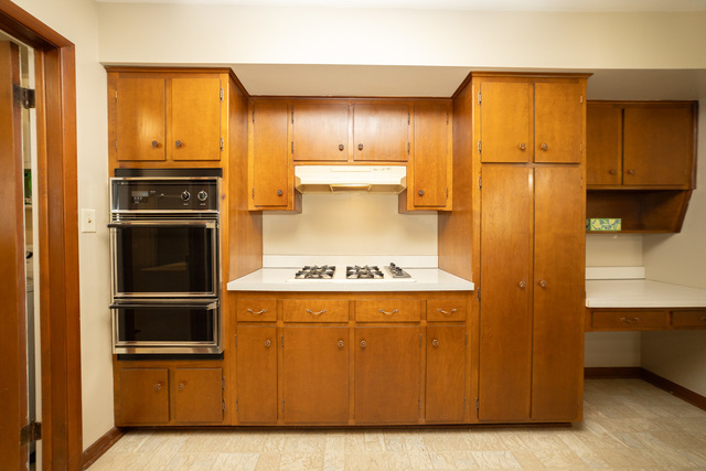 712 Homestead Place Joliet, IL 60435 - Photo 22 of 26 a view of a kitchen with a stove fridge and wooden floor