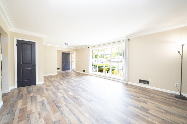 712 Homestead Place Joliet, IL 60435 - Photo 8 of 26 a big room with wooden floor and windows