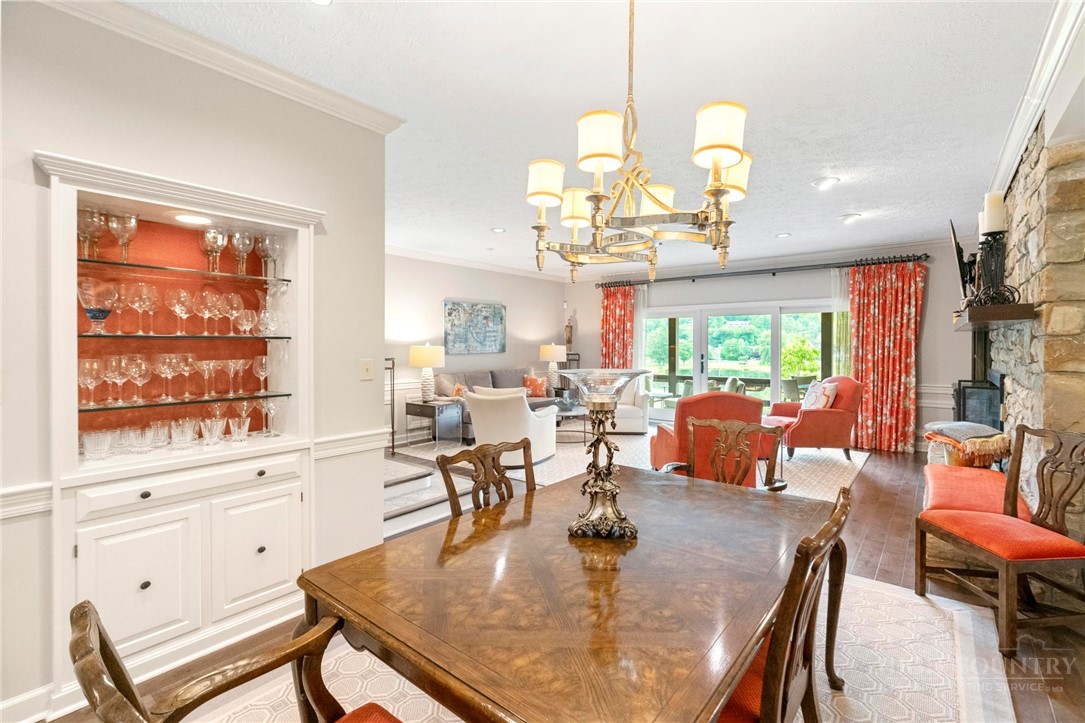 361 The Lakes, Unit C9 Boone, NC 28607 - Photo 10 of 47 a view of a dining room with furniture a chandelier and large windows