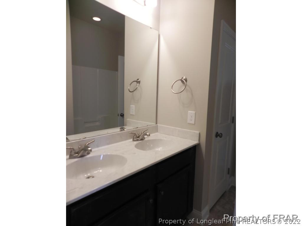 3589 Thrower Road Hope Mills, NC 28348 - Photo 8 of 17 a bathroom with a sink and a mirror