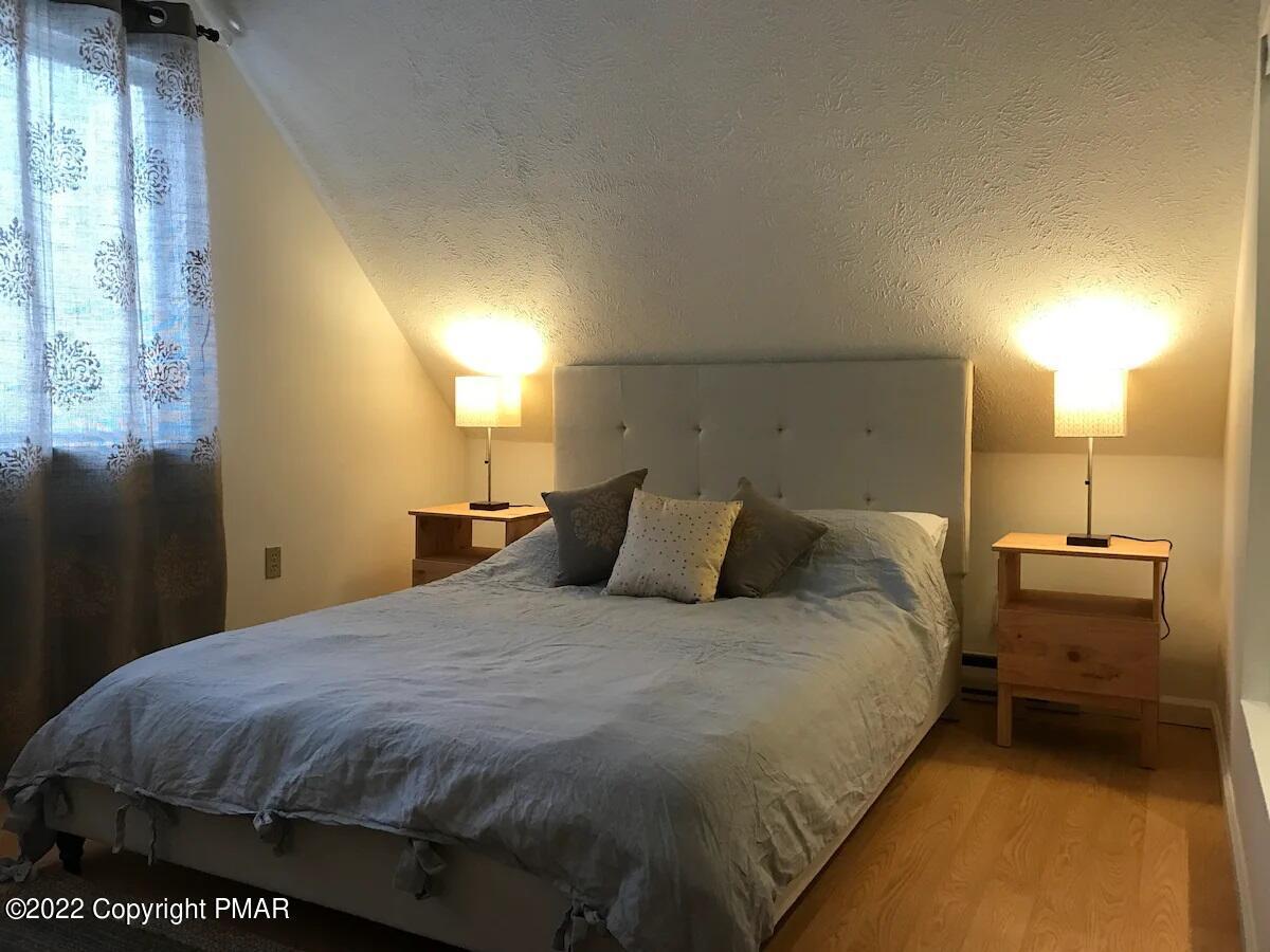 1421 Clover Road Long Pond, PA 18334 - Photo 14 of 31 a bedroom with a bed and a night stand