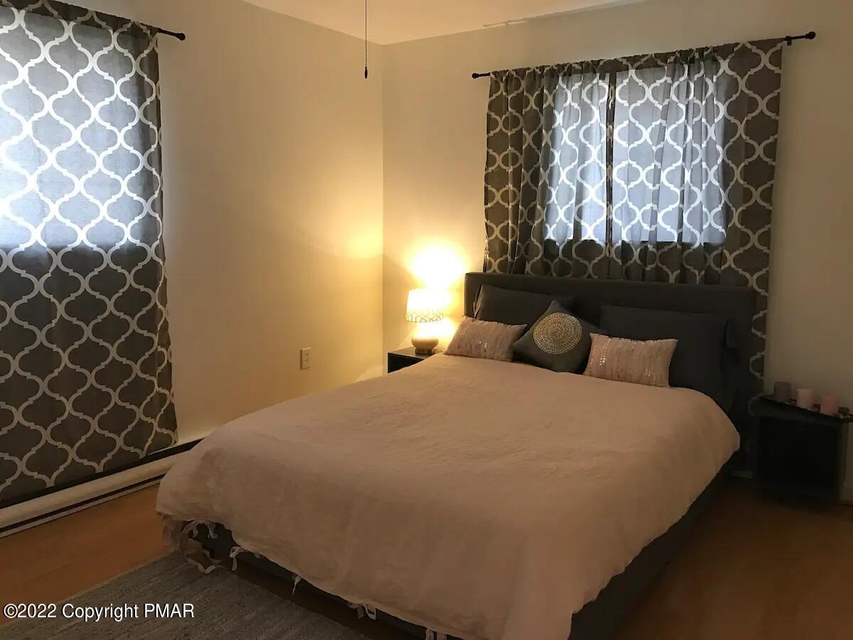 1421 Clover Road Long Pond, PA 18334 - Photo 19 of 31 a bedroom with a bed and a wall painting