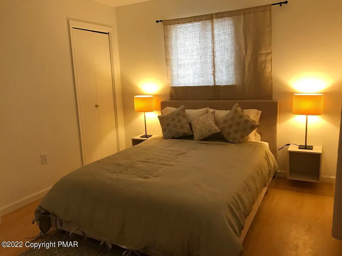 1421 Clover Road Long Pond, PA 18334 - Photo 20 of 31 a bedroom with a bed and lamps