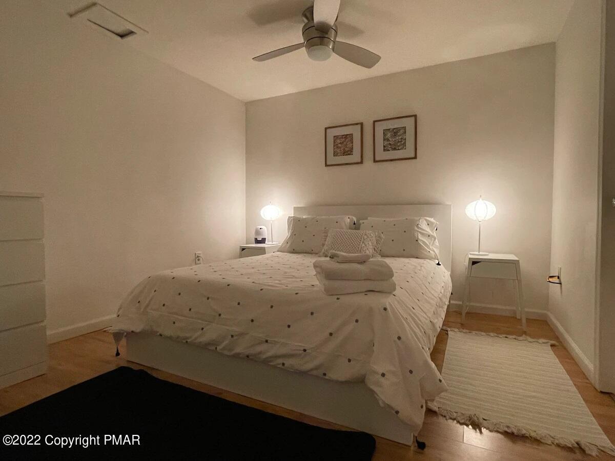 1421 Clover Road Long Pond, PA 18334 - Photo 27 of 31 a bedroom with a bed and wooden floor