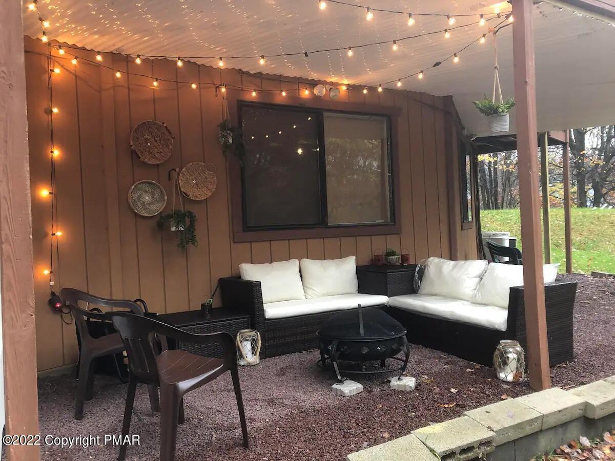 1421 Clover Road Long Pond, PA 18334 - Photo 29 of 31 a living room with couches and kitchen view with wooden floor