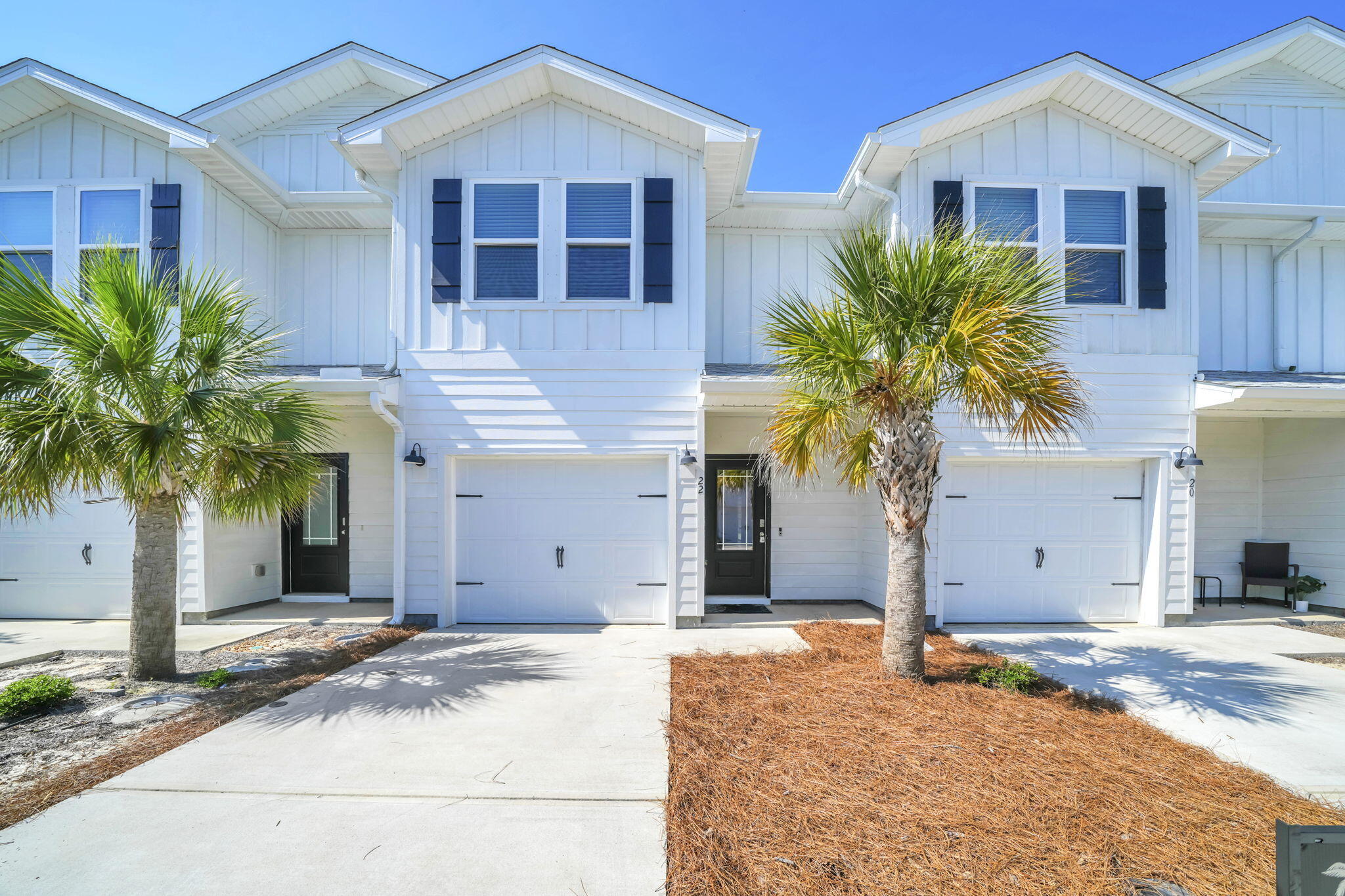 22 Redbird Loop Destin, FL 32541 - Photo 1 of 40 a front view of a house with a yard and garage