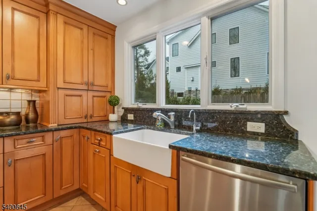 a kitchen with stainless steel appliances granite countertop a sink a stove and a microwave
