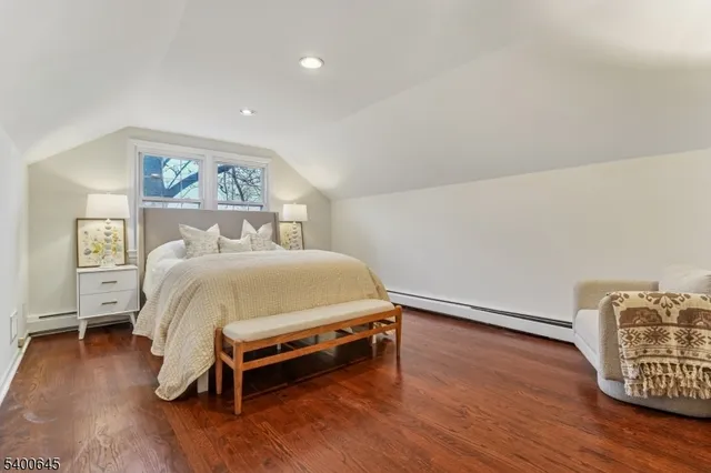 a bed sitting in a bedroom next to a wooden floor