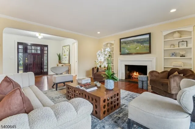 a living room with furniture a table and a fireplace