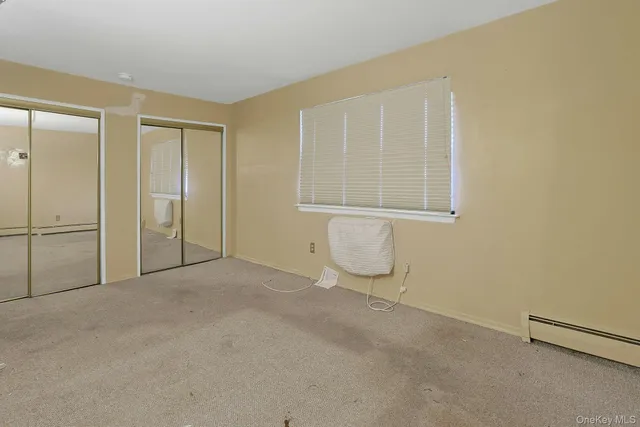 an empty room with a empty space and windows