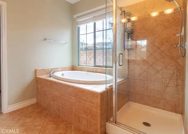 a bathroom with a tub and shower