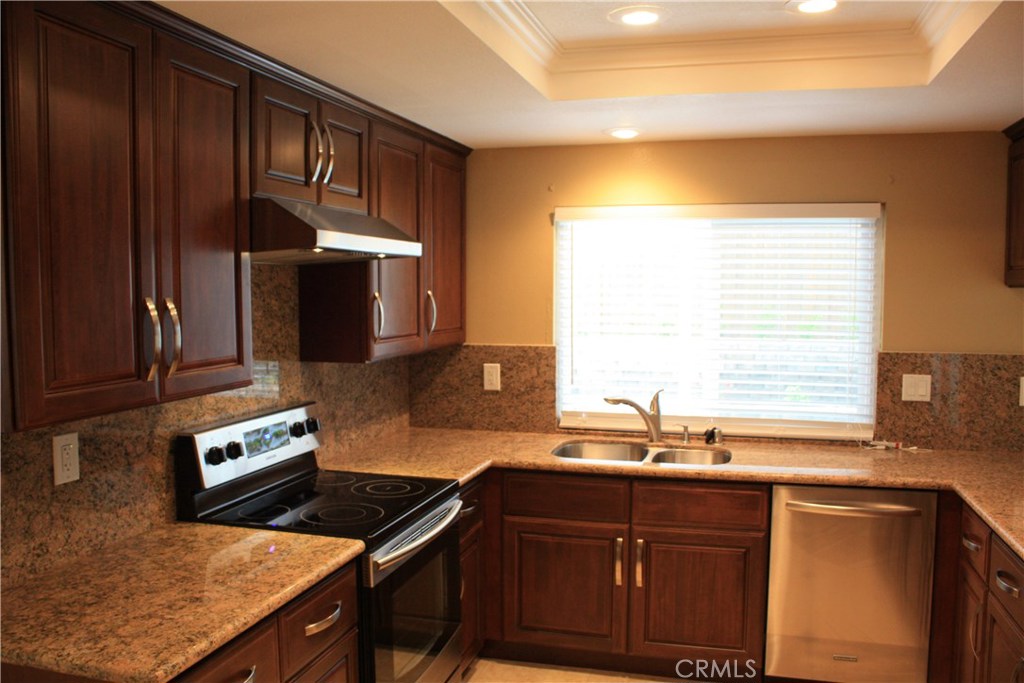 46 Oakdale Irvine, CA 92604 - Photo 11 of 26 a kitchen with wooden cabinets and a sink