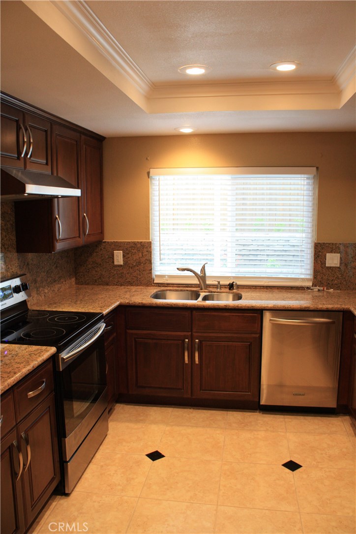 46 Oakdale Irvine, CA 92604 - Photo 12 of 26 a kitchen with granite countertop a sink and a stove top oven