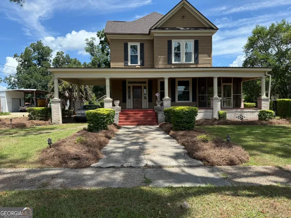 a front view of a house with garden