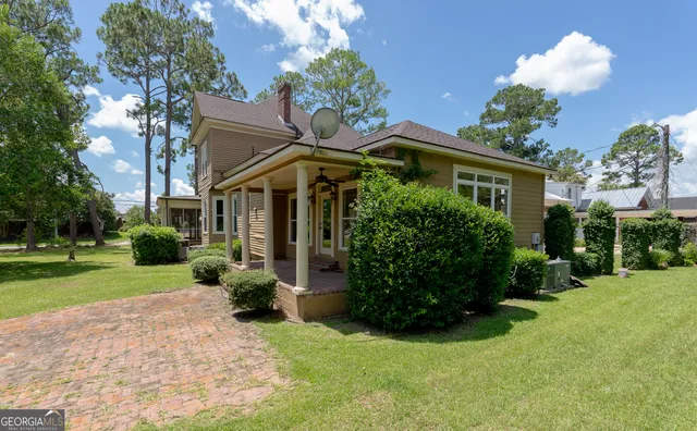 a front view of a house with garden