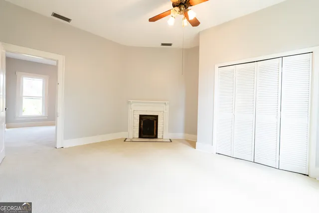 a view of a dining room with furniture a chandelier and wooden floor