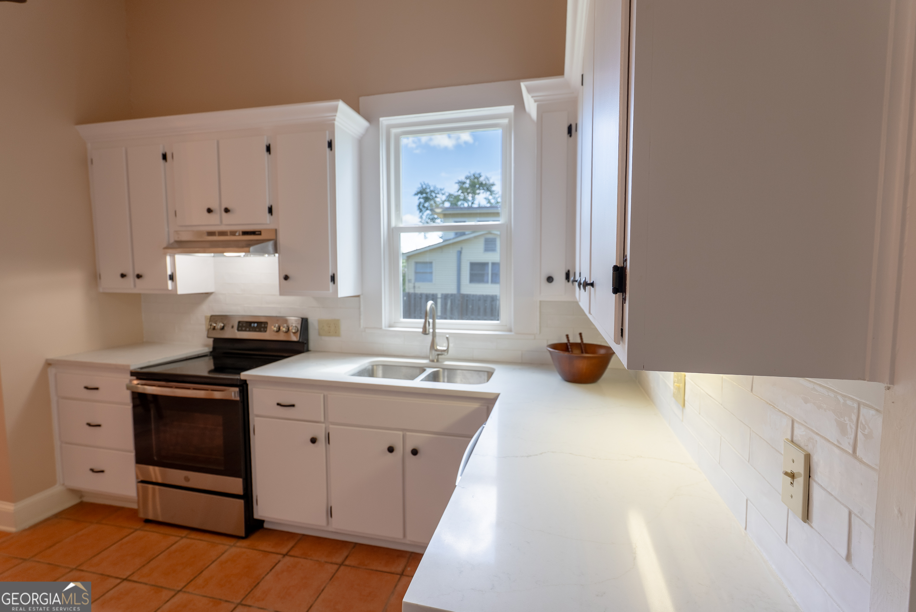 212 Hand Avenue West Pelham, GA 31779 - Photo 63 of 81 a kitchen with a sink stove and cabinets
