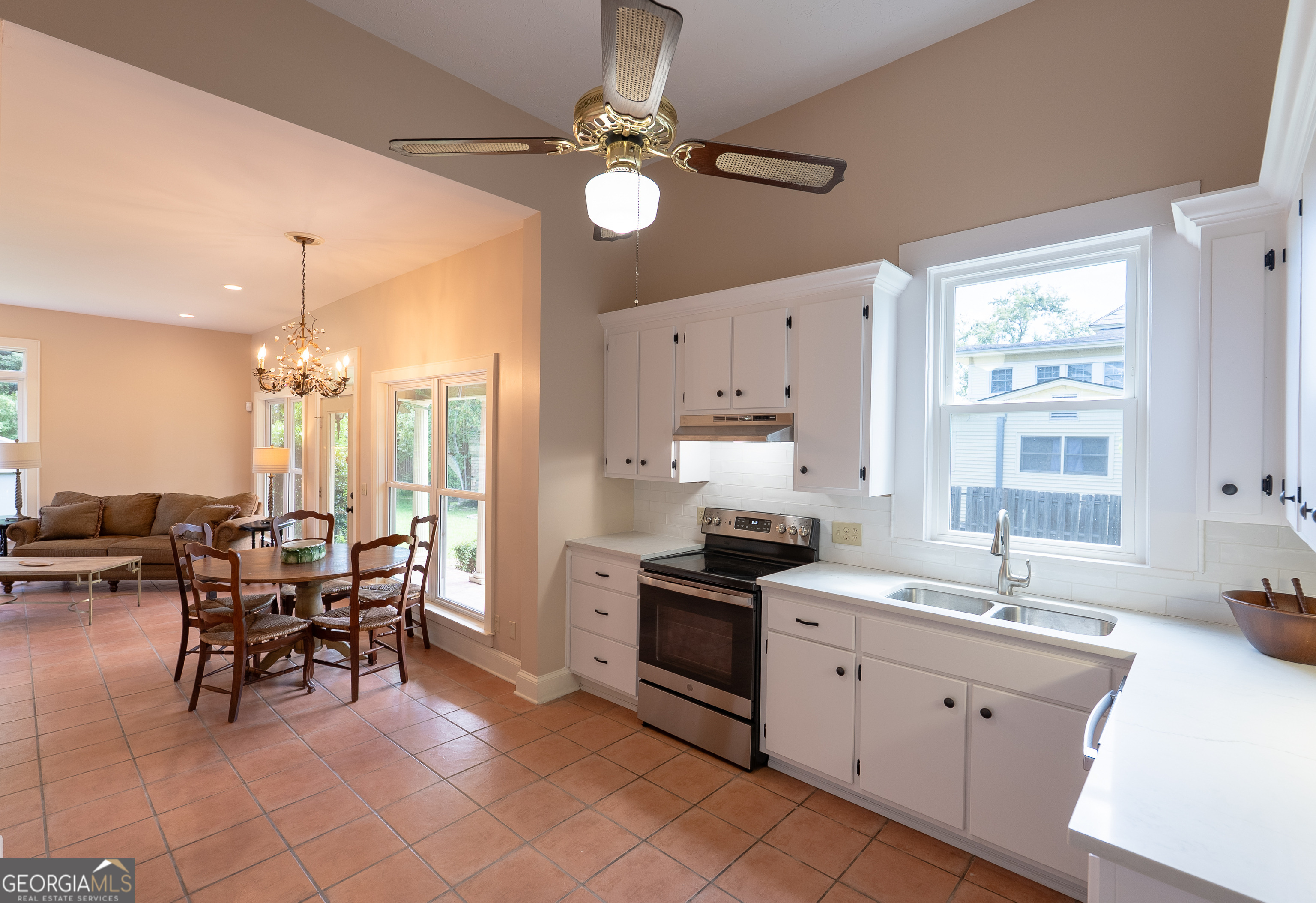 212 Hand Avenue West Pelham, GA 31779 - Photo 64 of 81 a kitchen with stainless steel appliances a stove a sink a dining table and chairs with wooden floor