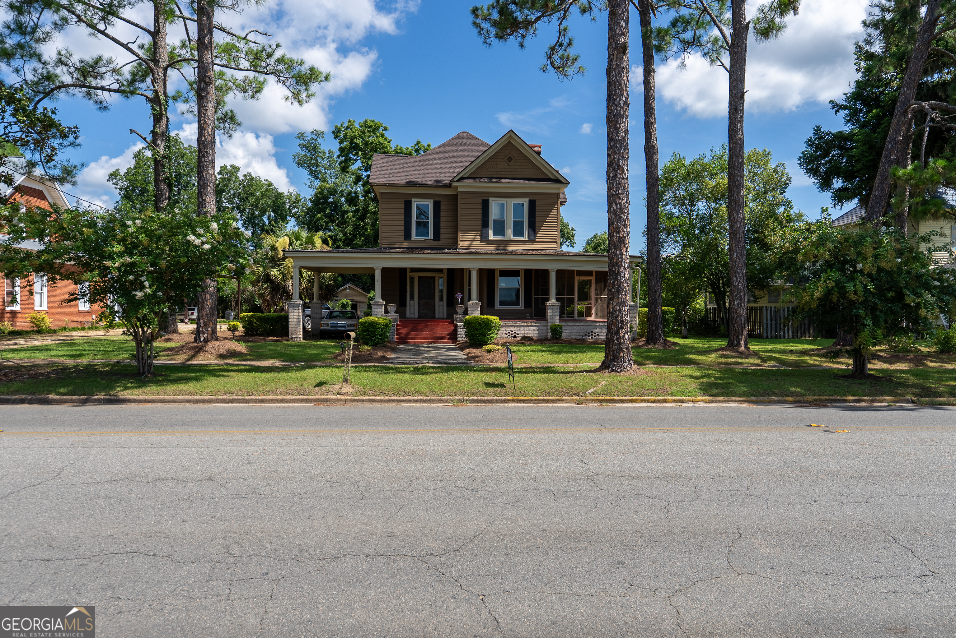 212 Hand Avenue West Pelham, GA 31779 - Photo 78 of 81 front view of a house with a yard and palm trees