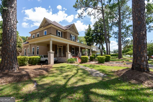 a view of a hallway with wooden floor and livingroom