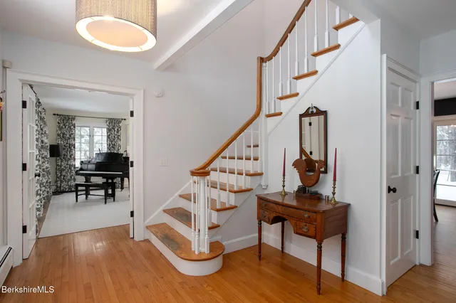 a view of entryway and hall with wooden floor